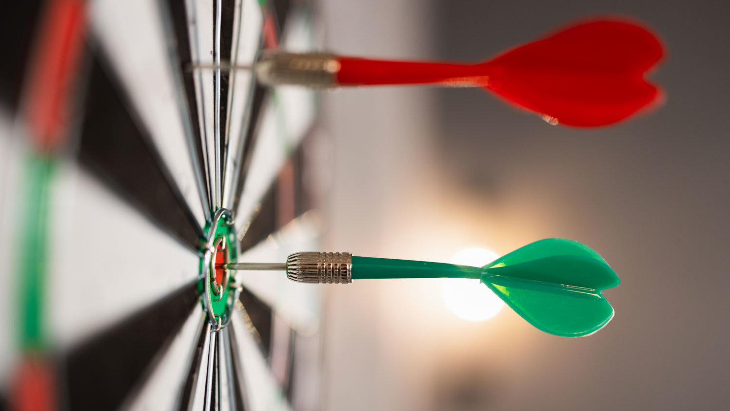 Dartscheibe mit zwei steckenden Pfeilen.